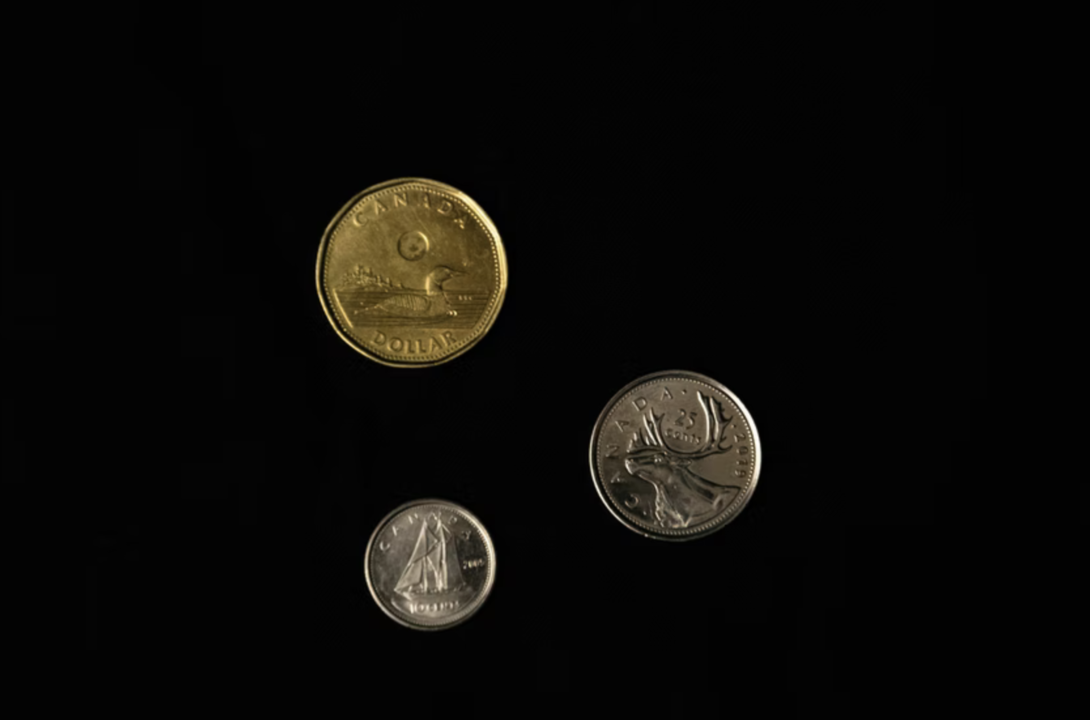 gold and silver coins on a black screen