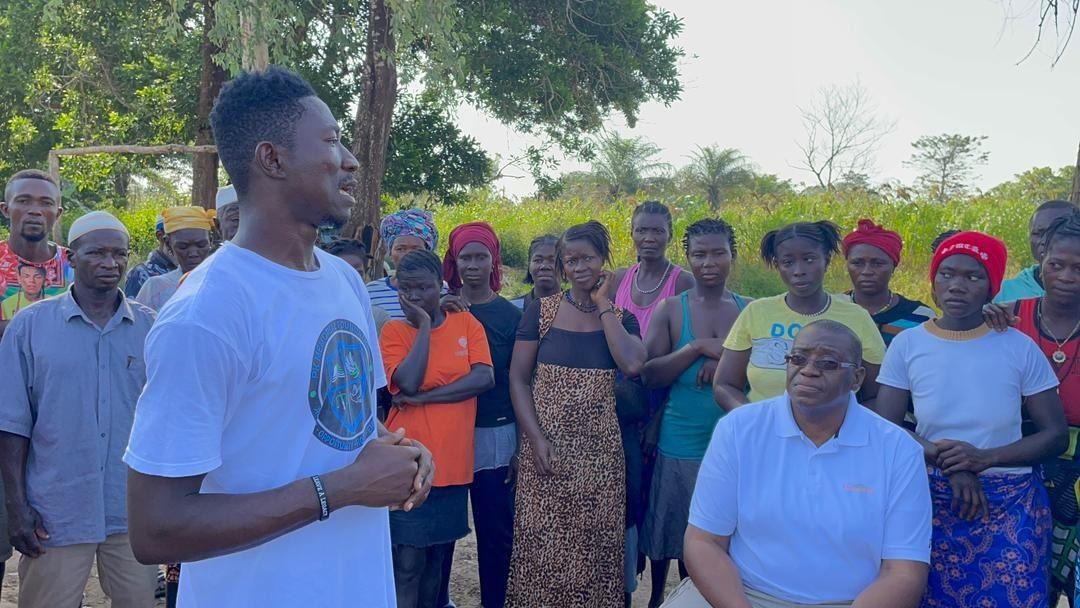 Community members gather as I share a few words with the village, November 2025