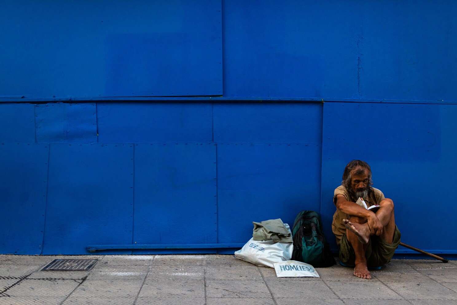 homeless man sitting on the floor