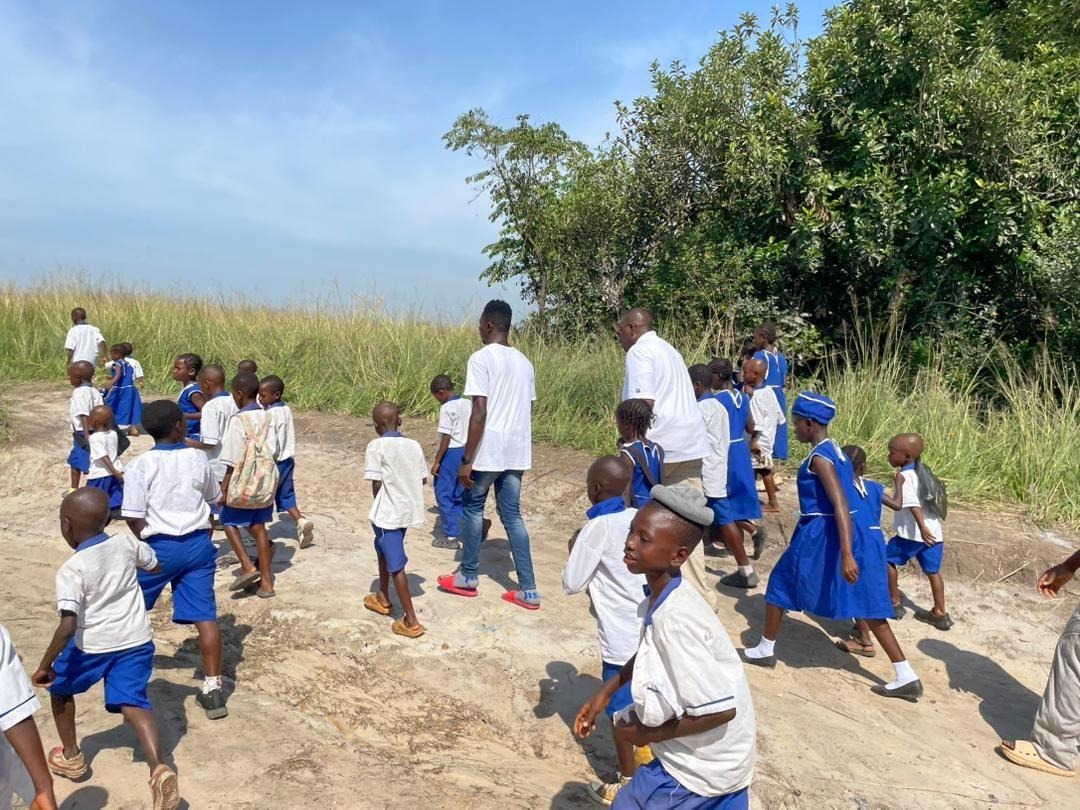 Students in Magbaikoli walking the path to school, November 2025
